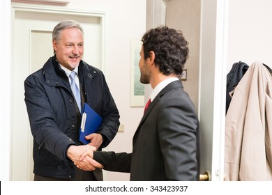 Businessman Welcoming A Guest In His Office