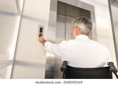 Businessman in wheelchair in corporate office using digital key to operate the lift - Powered by Shutterstock