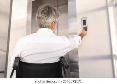 Businessman in wheelchair in corporate office using digital key to operate the lift - Powered by Shutterstock