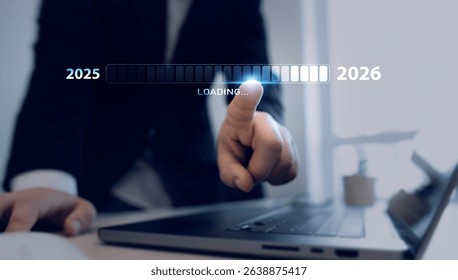 Businessman who touching the loading bar and the transition from the old year 2025 to 2026.Business plan in company 2026.Development to business success and achievement in 2026 year.