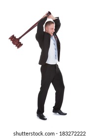 Businessman Wielding A Big Wooden Mallet Holding It Above His Head With Both Hands About To Smash It Downwards  Isolated On White