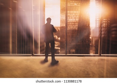 businessman at the window on the background of the futuristic city
 - Shutterstock ID 1130881178