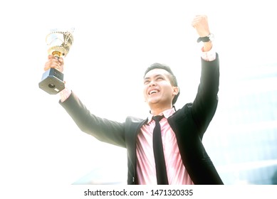 Businessman Wins A Trophy. Top Salesperson Concept