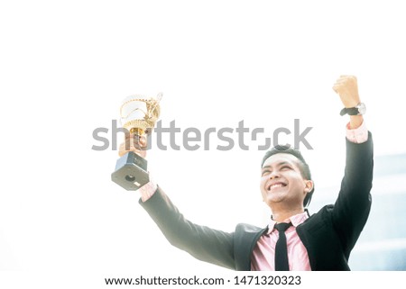 Businessman wins a trophy. Top salesperson concept