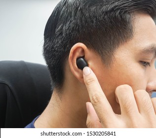 Businessman With Wireless Bluetooth Earphone Working With Computer In Office