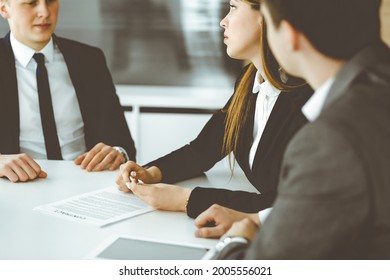 Businessman and woman with colleague sitting and working at the desk. Diverse business people discussing questions at meeting in modern office