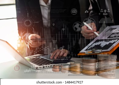 Businessman and woman discussing with the business team working documents at the office. Double exposure of graph and rows of coins for finance and business concept. - Shutterstock ID 1484417927
