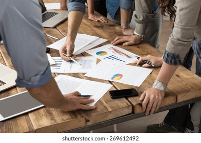 Businessman and woman discussing on stockmarket charts in office