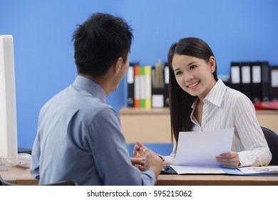 Businessman and woman looking at each other