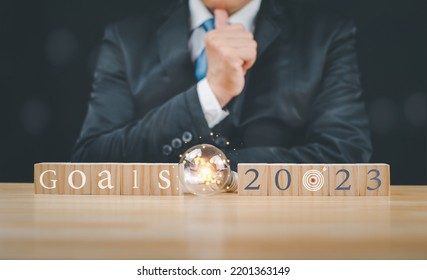 Businessman Wood Block Showing Business Planning, Investment, Currency, Bank, Asset Sale, Stock, Fund, To Success, Concept, Global Market Fundraising Goal In 2023.