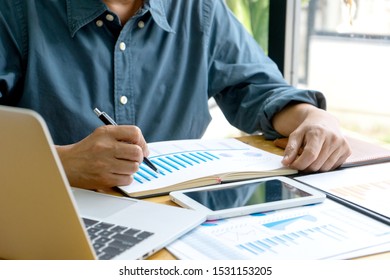 Businessman work about analysis marketing data in the office workplace.