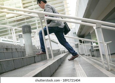 Businessman With Work Bag Going Up The Stairs In A Hurry, Focus On Legs And Feet. Climbing Corporate Ladder Or Work Success Concept.