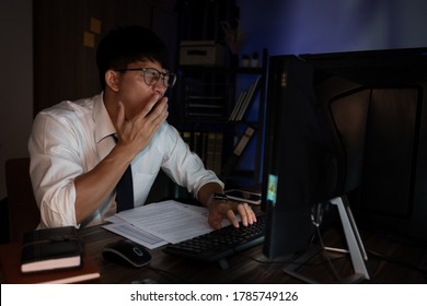 Businessman Workaholic Sit At The Computer Working Late At Night Yawn Tired And Sleeping In The Office,Hard Work In The Later Time Concept