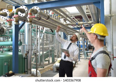 Businessman And Worker Meeting In A Factory - Maintenance And Repair Of The Industrial Plant 