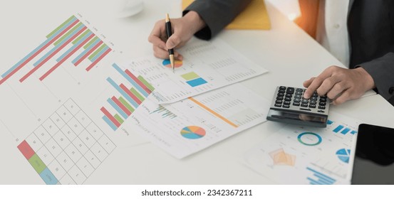 Businessman working with calculating and analyzing data at desk in office, Financial and business accounting concept. - Shutterstock ID 2342367211