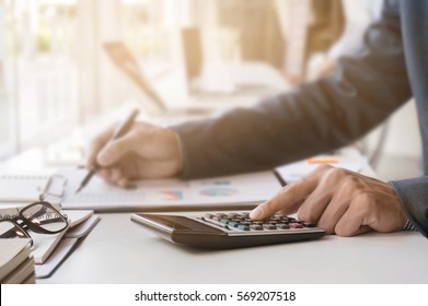 Businessman working with calculator and document data