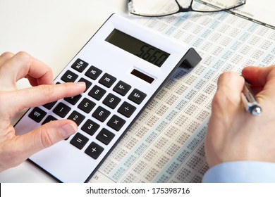 Businessman working with calculator in the office - Shutterstock ID 175398716