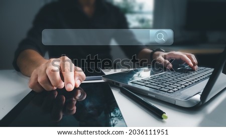 The businessman working with a computer laptop on a desk in the office. The concept is Search engine Browsing Internet Data Information with a blank search bar. Search Engine SEO Networking.