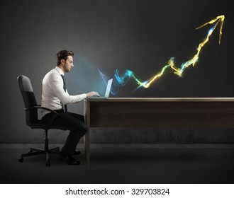 Businessman working at computer with light arrow