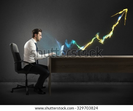 Businessman working at computer with light arrow