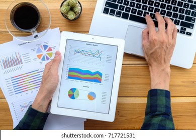 Businessman Working With Digital Tablet And Book And Document On Wooden Desk In Modern Office.Top View Business Analysis And Strategy Concept.