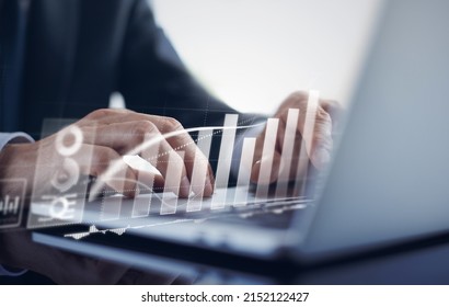 Businessman working with digital tablet computer virtual dashboard analyzing finance sales data and economic growth graph chart and account report, business finance and investment concept. - Shutterstock ID 2152122427