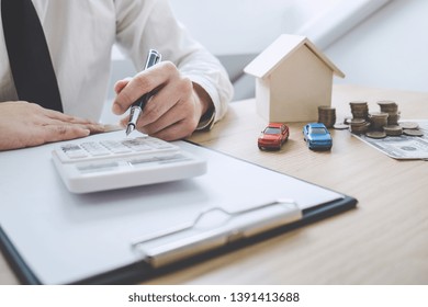 Businessman Working Doing Finances And Calculation Cost Of Real Estate Investment While Be Signing To Contract, Concept Mortgage Loan Approval.