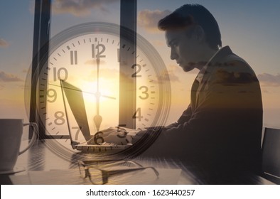  Businessman working early morning at office typing on computer. Time management, hard work, successful habits concept. 