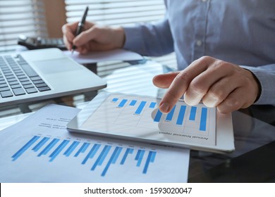 Businessman Working With Financial Report Charts, Business Analytics And KPI, Finance Concept