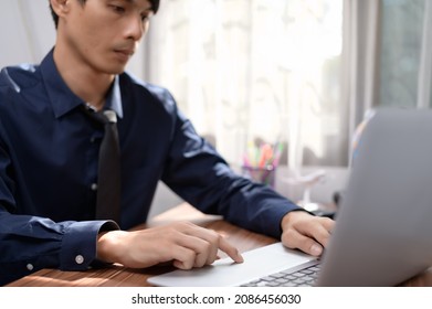 businessman working in front of a notebook computer at a desk - Shutterstock ID 2086456030