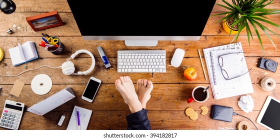 Businessman Working In His Office With Feet On Desk