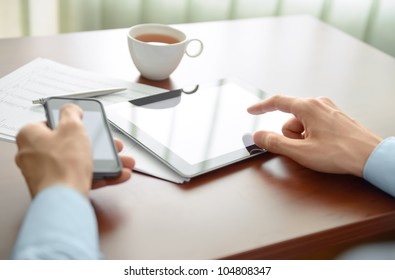 Businessman working at his workplace and using new technologies for success workflow.