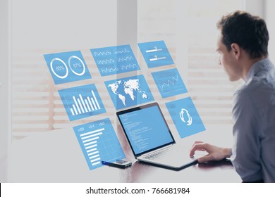 Businessman working with holographic augmented reality (AR) screen technology to analyze business analytics key performance indicator and charts on financial dashboard, fintech concept - Shutterstock ID 766681984