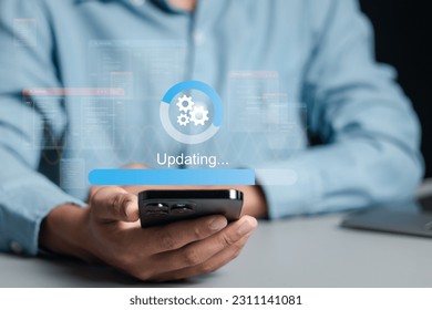Businessman working and installing update process. Software updates or operating system upgrades to keep your device up to date with enhanced functionality in new versions and improved security. - Shutterstock ID 2311141081