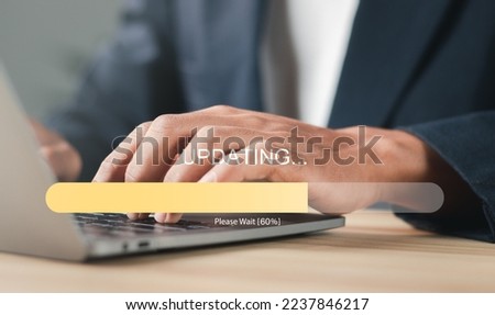 Businessman working and Installing update process. Software update or operating system upgrade to keep the device up to date with added functionality in new version and improve security.