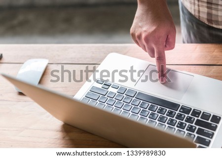 Businessman working laptop for new architectural project. Generic design notebook on the table. Blurred background.