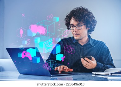 Businessman working with laptop and smartphone. Metaverse hologram with glowing icons and data blocks. Online gaming and nft. Concept of machine learning