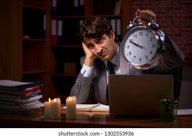 Businessman working late in office with candle light - Shutterstock ID 1302553936