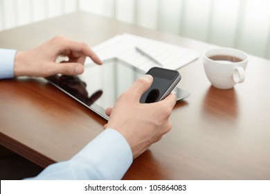 Businessman working with modern mobility devices, digital tablet and mobile phone at the office workplace. - Powered by Shutterstock - Get 15% off with code: PIKWIZARD15