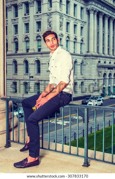 Businessman Working in New York. Wearing white\
shirt, black pants, leather shoes, a young college student sitting\
on railing in business district, thinking. Man Casual Fashion.\
Instagram effect.