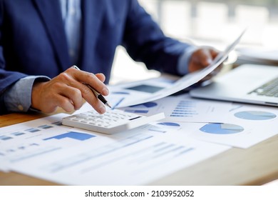 Businessman working at office with documents on his desk, doing planning analyzing the financial report, business plan investment, finance analysis concept