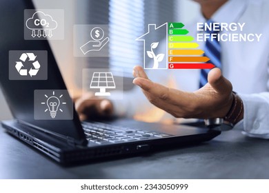 Businessman working in office with home energy efficiency rating label, which the energy labeling performance of residential and decision to buy it as value. ESG and green business CO2 emission reduce - Powered by Shutterstock