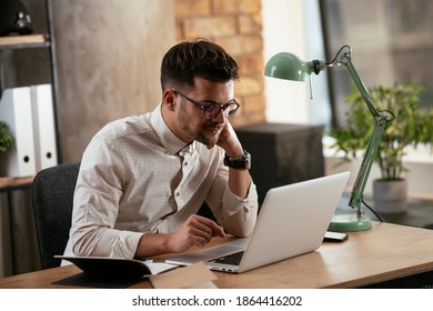 Businessman working in the office on his laptop. Stylish businessman working on a project in the office.	 - Shutterstock ID 1864416202