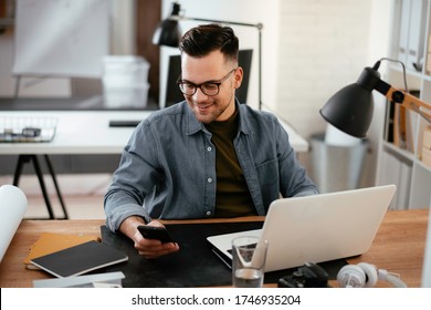 Businessman working in office. Young handsome man working on lap top.  - Shutterstock ID 1746935204
