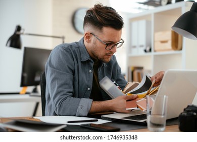 Businessman working in office. Young handsome man working on lap top.  - Shutterstock ID 1746935348