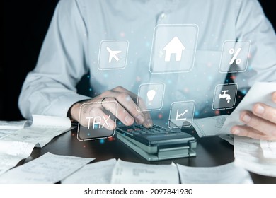 Businessman working on calculator to calculate the invoices costs, accountancy document at office, business concept. Tax and house icons on virtual screen - Shutterstock ID 2097841930