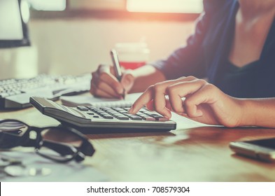 businessman working on desk office using calculator business financial accounting concept