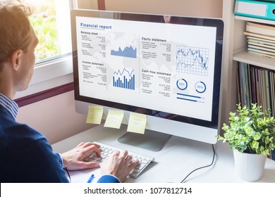 Businessman Working On Financial Report Of Corporate Operations On Computer Screen With Balance Sheet, Income Statement, And Key Performance Indicators