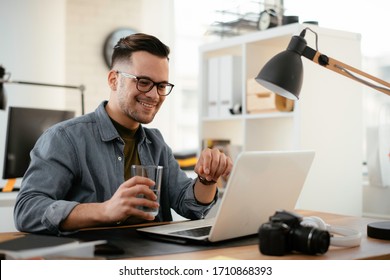Businessman working on his laptop.
Young handsome man working in office.