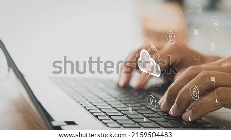 businessman working on his laptop in the home office selects icon cloud on the virtual display. cloud computing technology, internet security, data protection, blockchain, and cyber security concept.